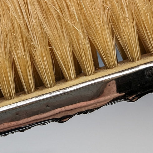Antique American sterling silver brush with embossed handle