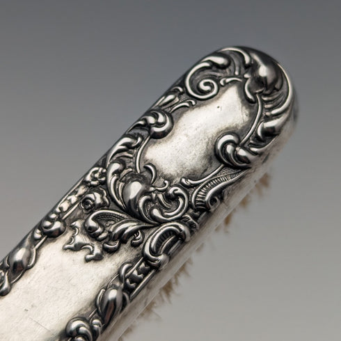 Antique American sterling silver brush with embossed handle
