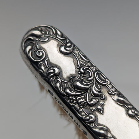 Antique American sterling silver brush with embossed handle