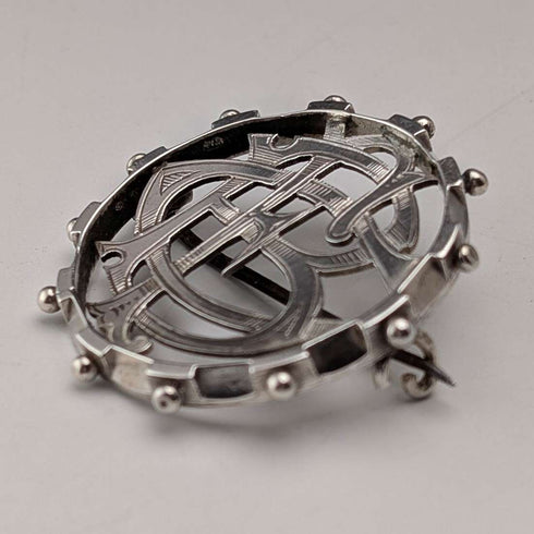 Antique sterling silver monogrammed round brooch