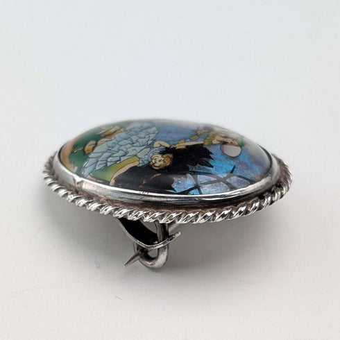 Vintage British sterling silver oval brooch featuring two women with butterfly wings