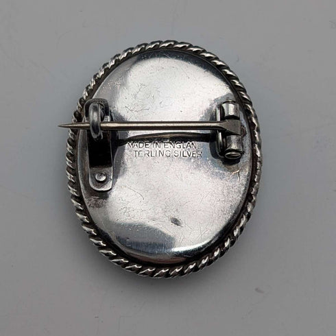 Vintage British sterling silver oval brooch featuring two women with butterfly wings