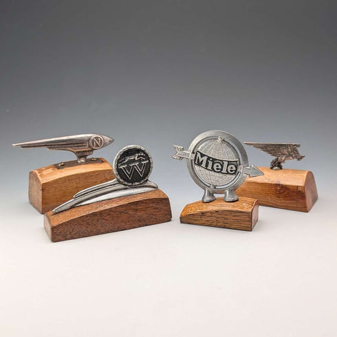4 vintage Fender mascots with wooden stands