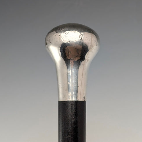 British antique black shaft sterling silver plain rondelle handle walking stick, 87cm