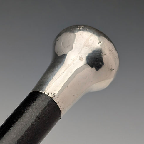 British antique black shaft sterling silver plain rondelle handle walking stick, 87cm